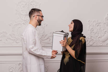 Muslim couple, a man makes a gift to his woman. Surprise from husband to wife