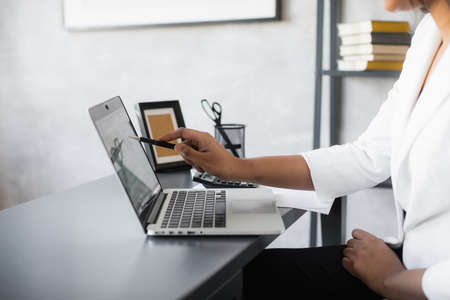 Black Business woman using laptop for analyzing data stock market, forex trading graph, stock exchange trading online, financial investment concept. close upの写真素材