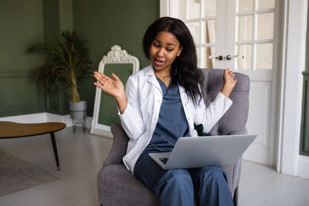 Black female doctor. Telemedicine the use of computer and telecommunications technologies for the...