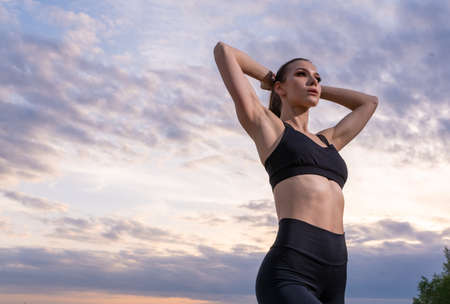 fitness and lifestyle concept - woman doing sports outdoors on a beach