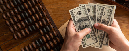 Business man counting money, saving money, and taking notes for the future And calculate income-expenses for the family, money-saving ideas and counting moneyの写真素材