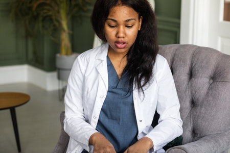 Black doctor. Telemedicine the use of computer and telecommunications technologies for the exchange of medical informationの写真素材