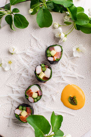 Top view of healthy Japanese sushi roll without rice with crab meat wrapped in daikon radishの写真素材