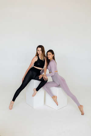 Beautiful sporty women do exercises on a white background. Fitness.の写真素材