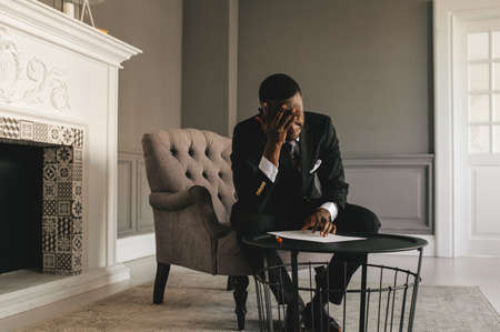 young african american businessman in business suit taking notesの写真素材