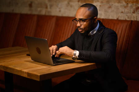 african american business man student entrepreneur study online course with laptop, serious young...