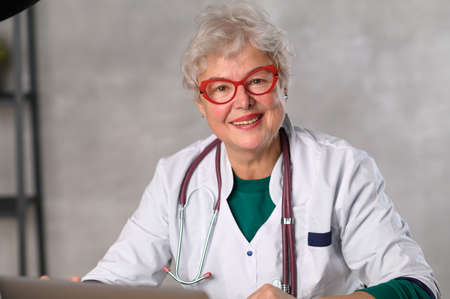 Middle age Woman doctor. Telemedicine the use of computer and telecommunications technologies for the exchange of medical informationの写真素材