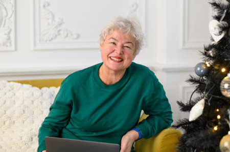 grandma is talking on a video conference with her family. Modern means of communication