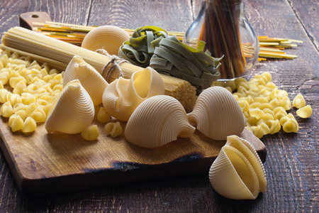 Different raw pasta on the tableの写真素材