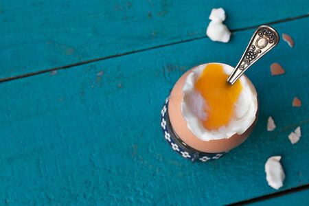 Hard-boiled egg on the blue wooden table horizontal