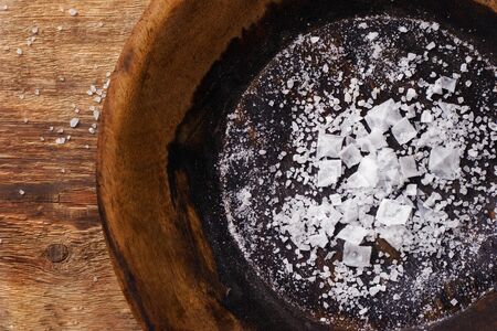 Various sea salt on the vintage wooden plate