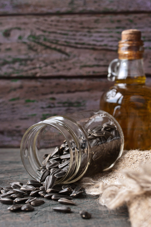 Sunflower seeds in a glass jar on the rustic wooden tableの写真素材