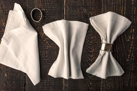 Set of the napkins with vintage ring on the wooden table horizontalの写真素材
