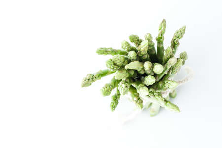 Bundle of asparagus on the white background top viewの写真素材