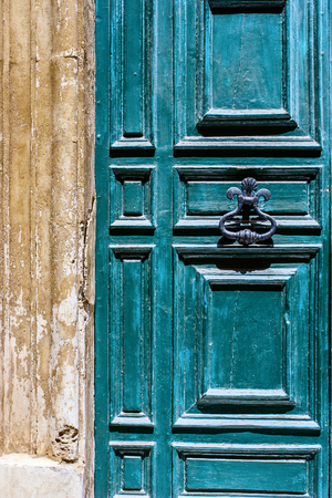 Blue maltese door with  old forged handleの写真素材