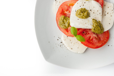 Caprese salad on the white square plate top viewの写真素材