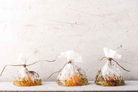 Raw eggs with seasoning in the transparent bagsの写真素材