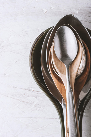 Different spoons on the  white table verticalの写真素材