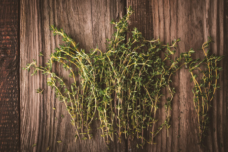 Thyme on the old wooden board horizontalの写真素材