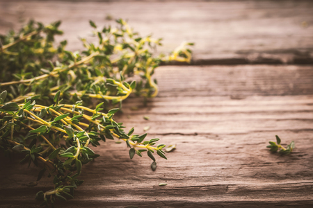 Bundle of thyme on the old wooden boardの写真素材