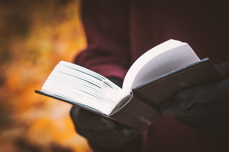 Open book in the hand of the womanの写真素材