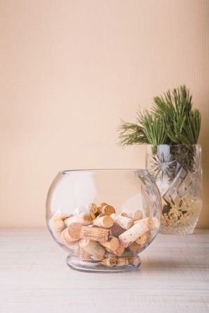 Vase with corks and coniferous branch on the table verticalの写真素材