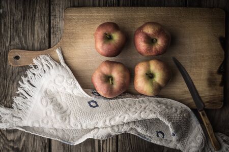 Red apples and towel on the cutting board horizontalの写真素材