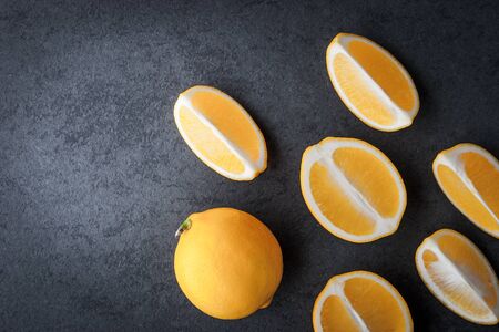 Yellow lemons on a blue stone table horizontalの写真素材