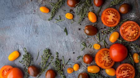 Tomatoes mix  with herbs on the stone tableの写真素材