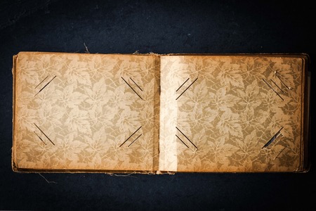 Open empty vintage photo album on the dark stone tableの写真素材