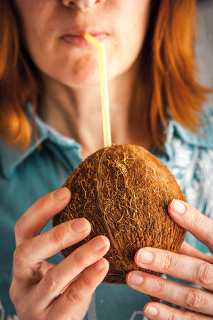 Woman drinking coconut milkの写真素材