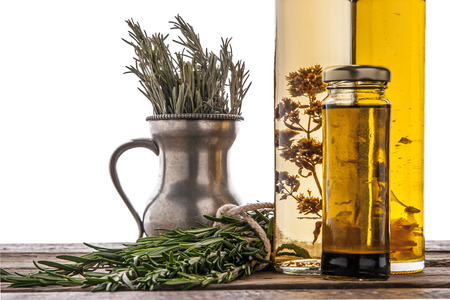 Olive oil with herbs on the wooden tableの写真素材