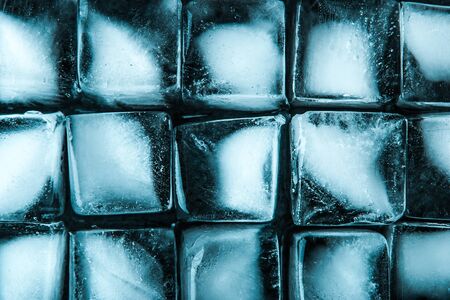 Ice cubes on the dark stone table  top view