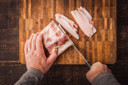 Cutting lard on the wooden board top viewの写真素材
