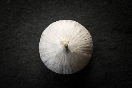 Garlic on the black stone table  top viewの写真素材