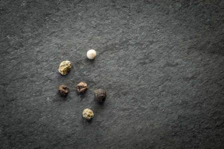 Corn of peppers on the black stone table top viewの写真素材