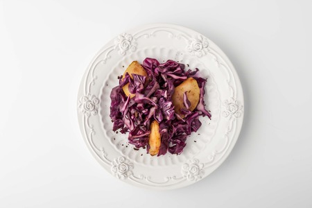 Salad of red cabbage and apple on a plate with a relief pattern horizontalの写真素材
