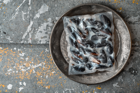Frozen Mussels vacuum packed on a metal plate horizontalの写真素材