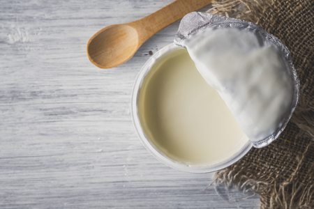 Natural yogurt on the white wooden table, top viewの写真素材