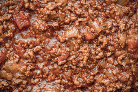 Stew meat with seasoning and tomatoes backgroundの写真素材