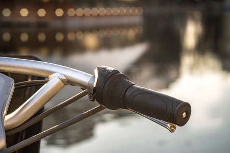 Part of the bicycle wheel in front of the pondの写真素材