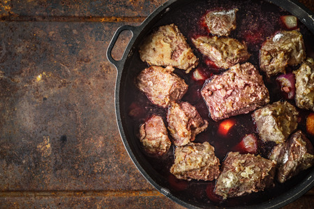 Boeuf Bourguignon in the pan on the metal background top viewの写真素材