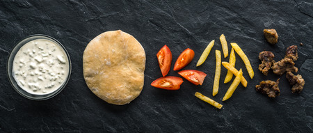 Ready-made ingredients for Gyros on black stoneの写真素材