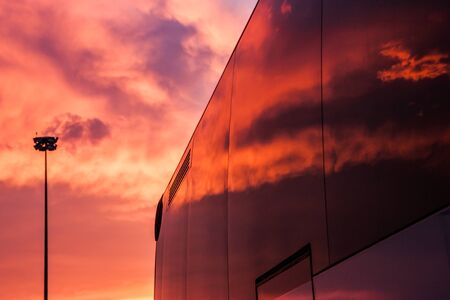 Sunset sky reflected on the window of the busの写真素材