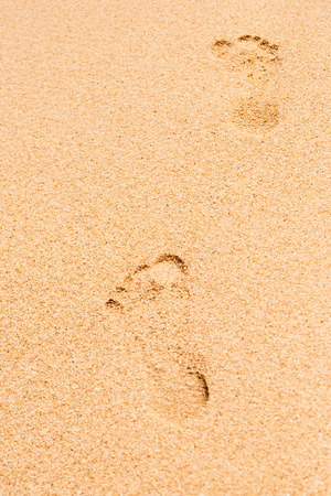 Footprints in the sand verticalの写真素材