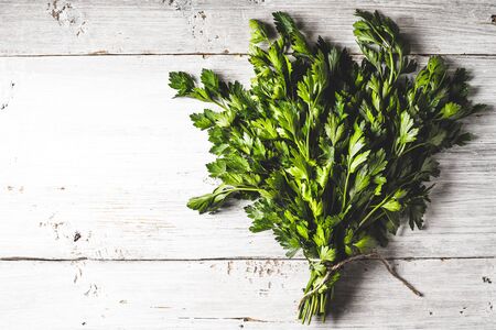 Bunch of parsley on the white wooden table horizontalの写真素材