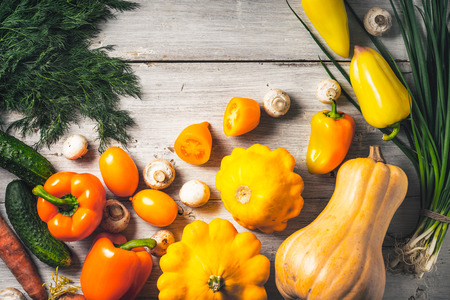 Yellow and green vegetables on the white wooden table top viewの写真素材