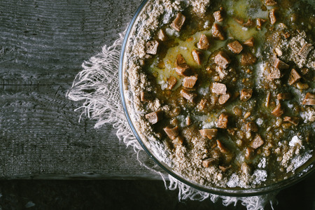 Raw pumpkin dump cake in the baking dish on the wooden table top viewの写真素材