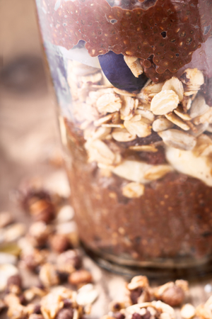 Chocolate chia pudding with oat flakes in the glass jarの写真素材