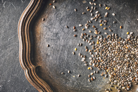 Chia seeds on the old metal tray top viewの写真素材